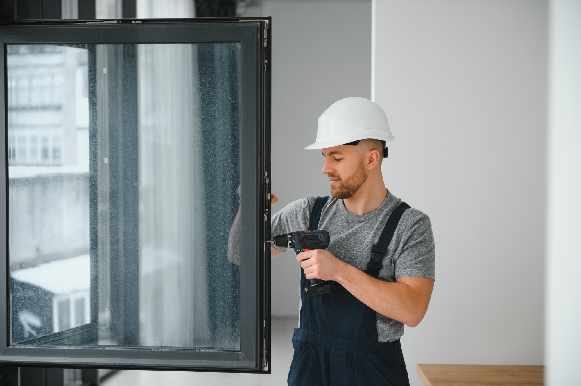 Professional master at repair and installation of windows, at work.